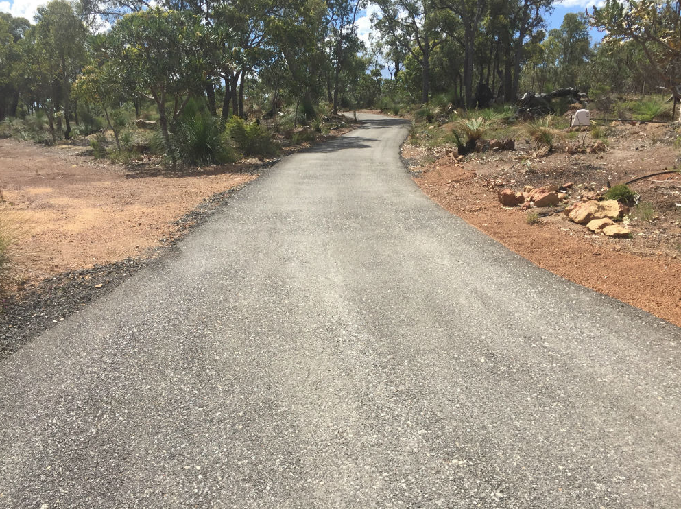 This is a photo of a hot spray & seal bitumen driveway which is in the process of being installed by Camberwell Road Tech