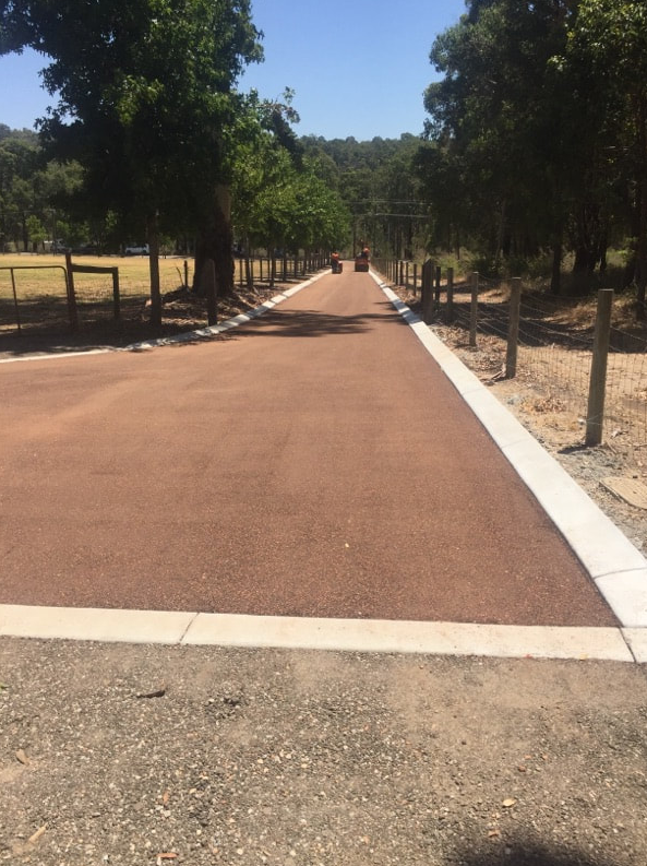 This is a photo of a hot spray & seal bitumen roadway which is in the process of being installed by Camberwell Road Tech